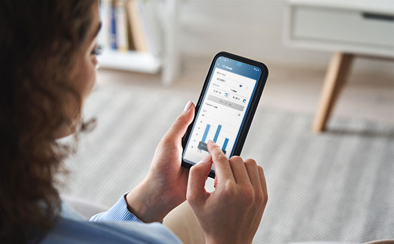 woman holding smartphone and using Aquarion mobile app