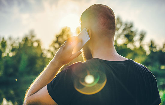 young man making phone call outdoors