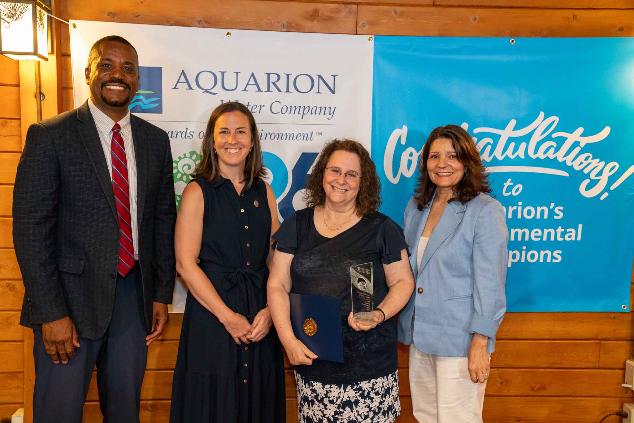 non-profit-winner PHOTO (left to right): George Logan, Director of Community Relations at Aquarion Water Company; Ashley Gaudiano, Trumbull Town Council Chair; Sheryl Baumann, Director of the Trumbull Nature & Arts Center; and Lucy Teixeira, President of Aquarion Water Company.